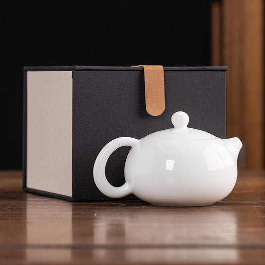 Front view of a 160ml Dehua Mutton Fat Jade White Porcelain Xishi teapot with a smooth, translucent glaze and a classic rounded silhouette wooden table.