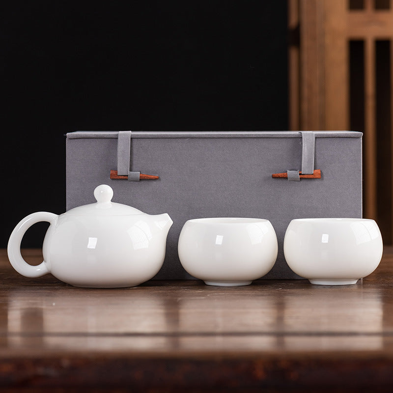 Front view of a premium Dehua Blanc de Chine Xishi tea set with 2 Zen cups and a luxury gift box, showcasing the translucent mutton fat jade texture