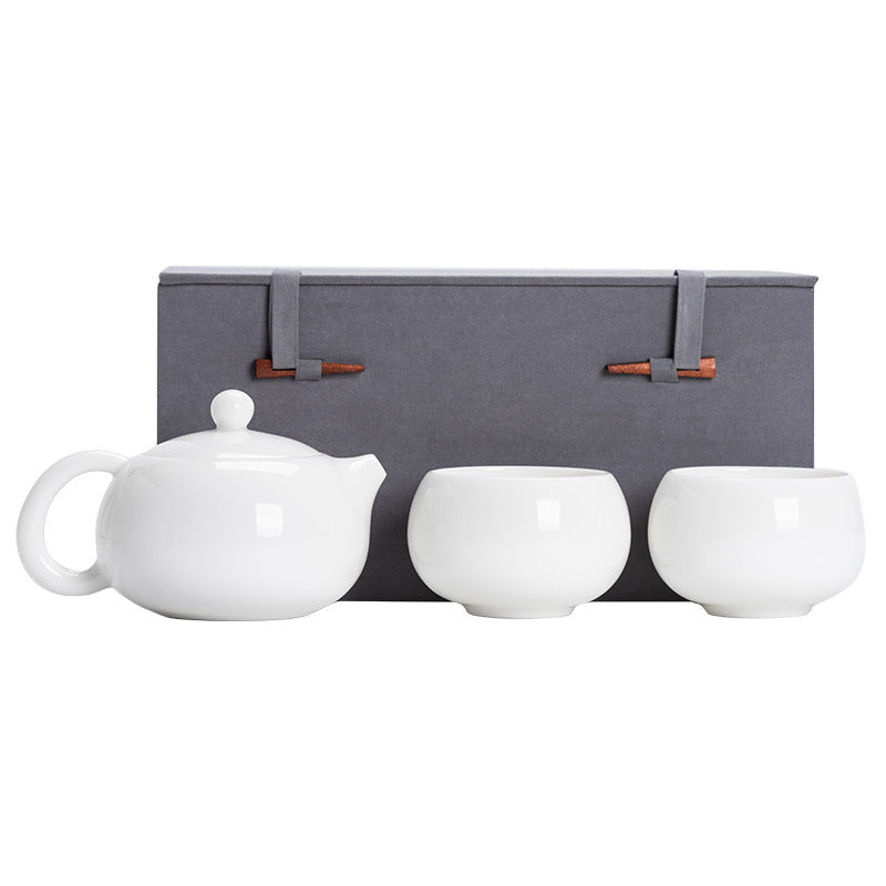 Professional studio front view of a 160ml Dehua Mutton Fat Jade porcelain Xishi teapot set with two matching cups and a luxury gift box on a seamless white background.