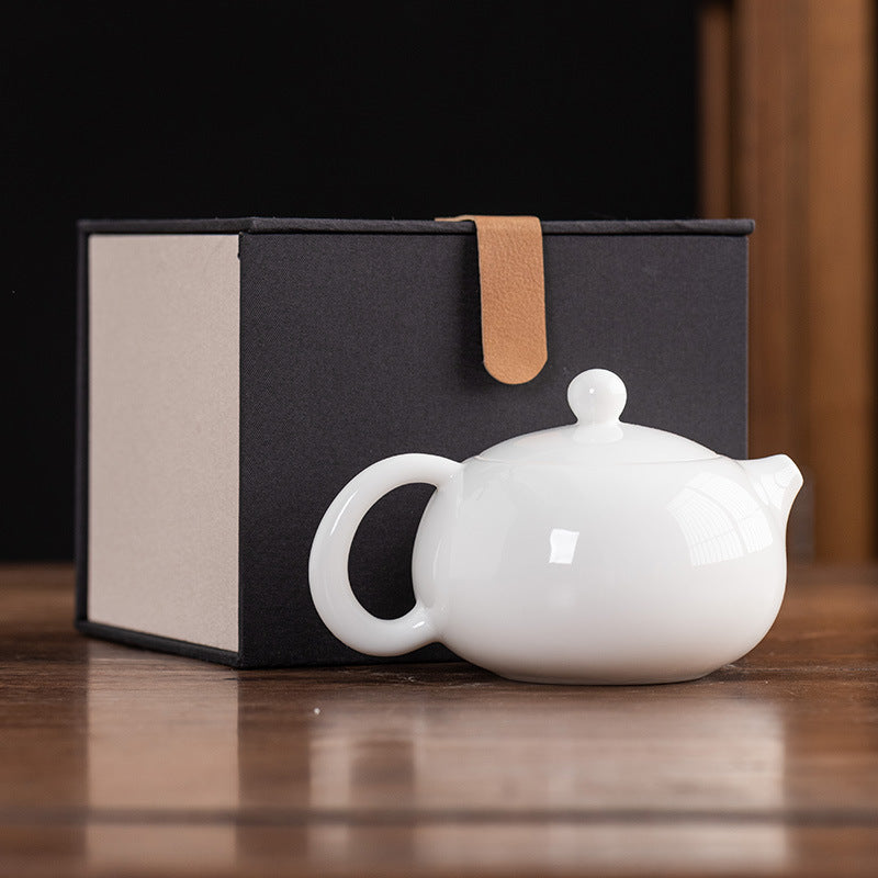 Front view of a 160ml Dehua Mutton Fat Jade White Porcelain Xishi teapot with a smooth, translucent glaze and a classic rounded silhouette wooden table.