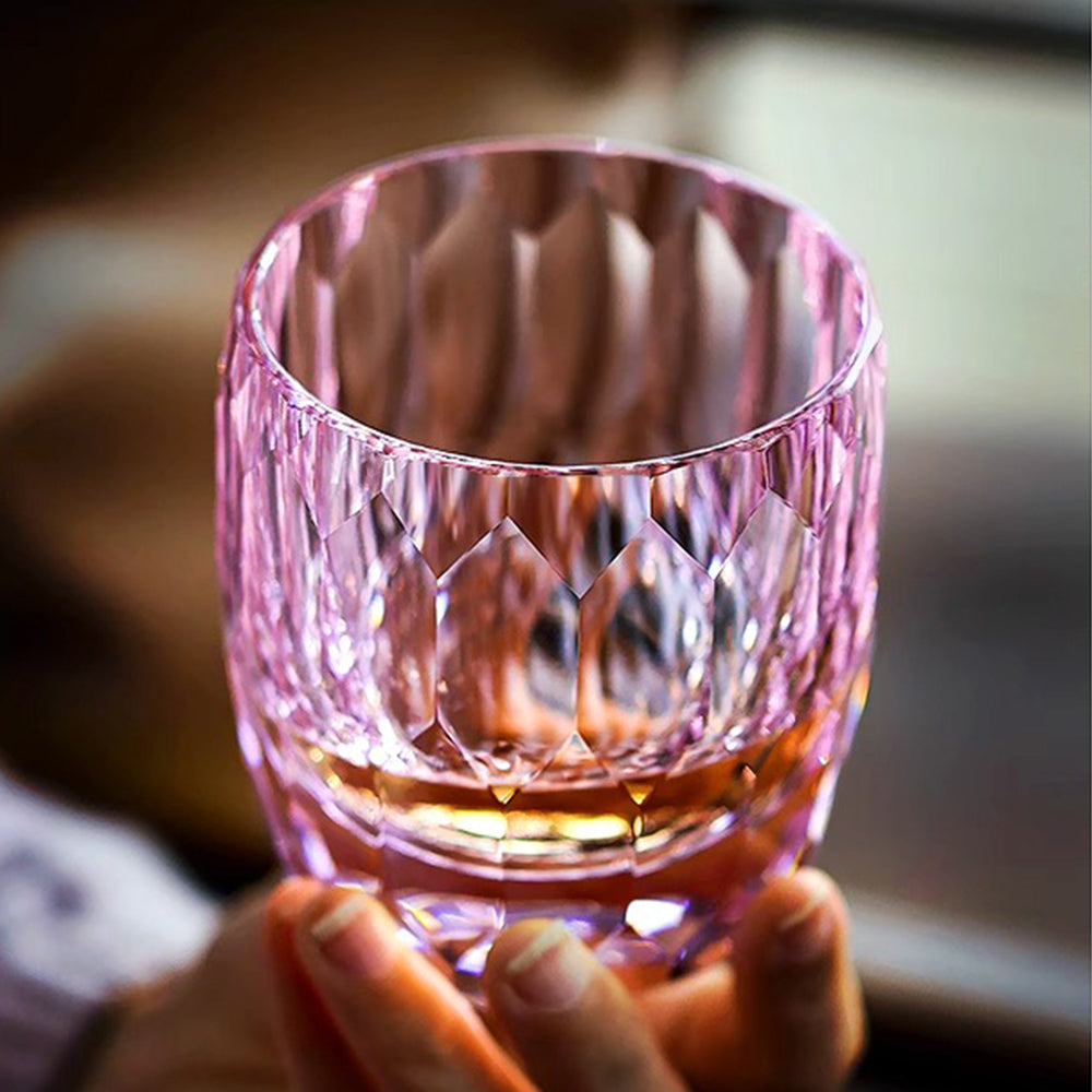 Pink Edo Kiriko-inspired diamond cut crystal whisky glass held by hand