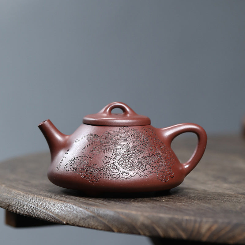 Close up of a Pan Pot Yixing Zisha teapot handmade by artist Fan Qinjun, showing the authentic texture of Zini Purple Clay sourced from Yixing. Founded and operated by a U.S. Ph.D. graduate, JiangnanSourcing.com is dedicated to providing high-quality, authentic teaware.