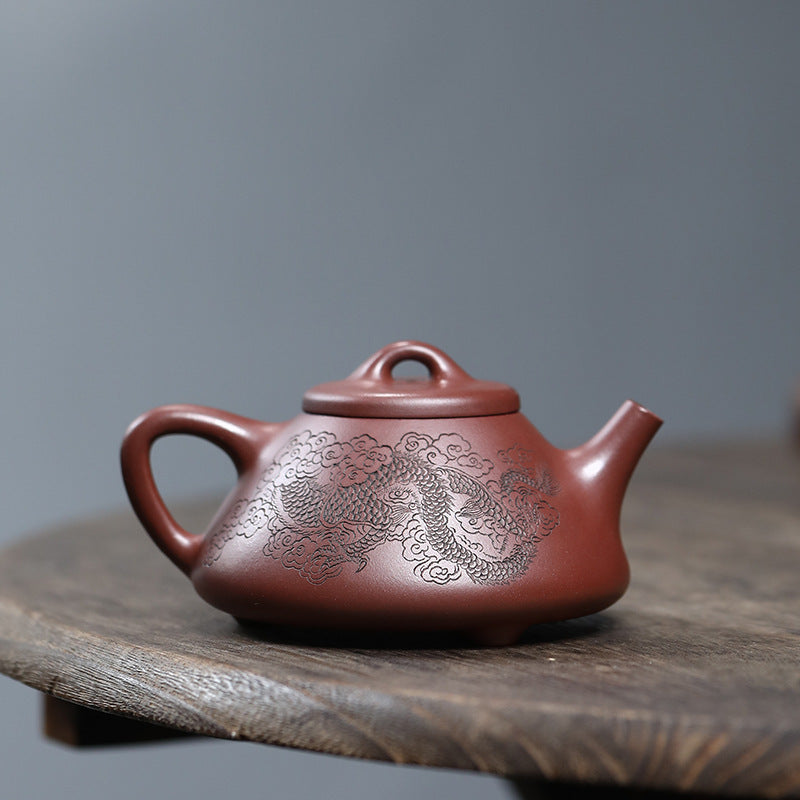 Close up of a Pan Pot Yixing Zisha teapot handmade by artist Fan Qinjun, showing the other side dragon texture of Zini Purple Clay sourced from Yixing vetted for craftsmanship and clay purity by the U.S. Ph.D. founder of JiangnanSourcing.com to ensure museum-grade quality.
